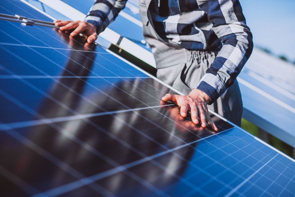 Man worker firld by solar panels 1 compressed